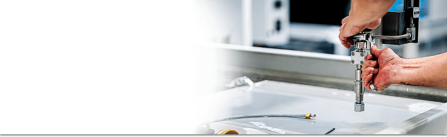 A Flow Waterjet Technician working on a Paser 4 Cutting Head